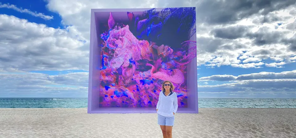 Abstract art installation on Miami Beach with a person standing in front.