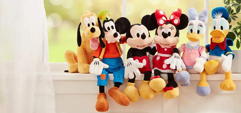 Soft Disney plush toys featuring characters like Mickey, Minnie, and other beloved Disney figures.