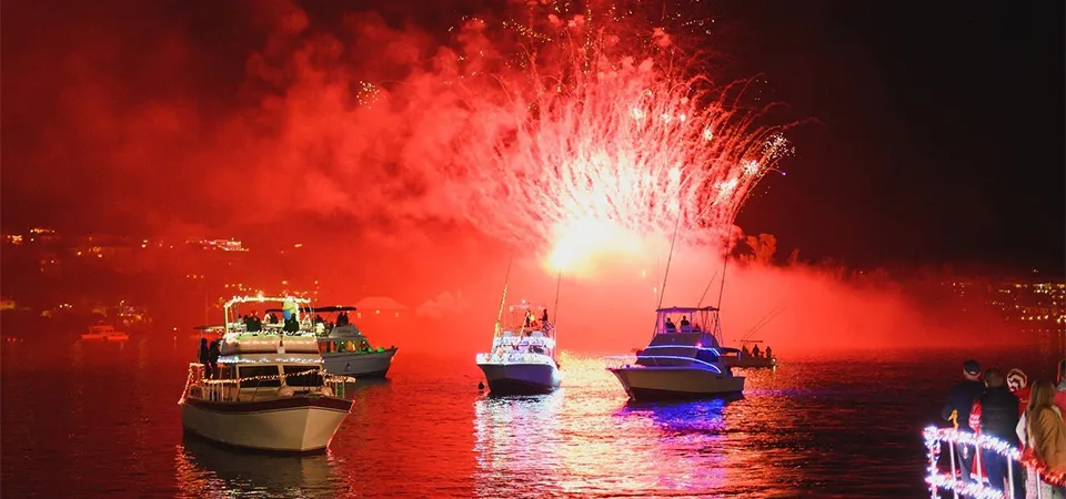 Festive boats under red fireworks in Miami.